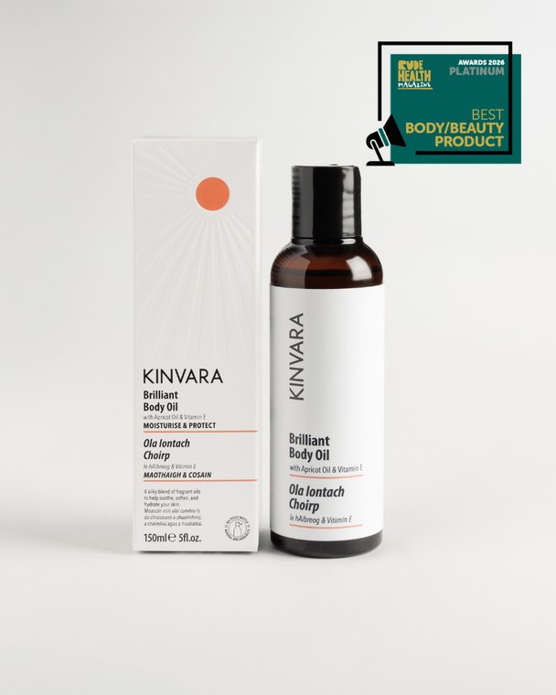 Brilliant Body Oil bottle beside its carton, with an awards badge