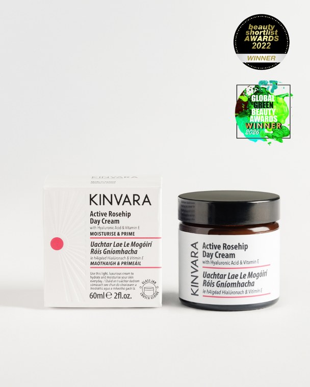 Active Rosehip Day Cream in a glass jar beside its carton, with award badges