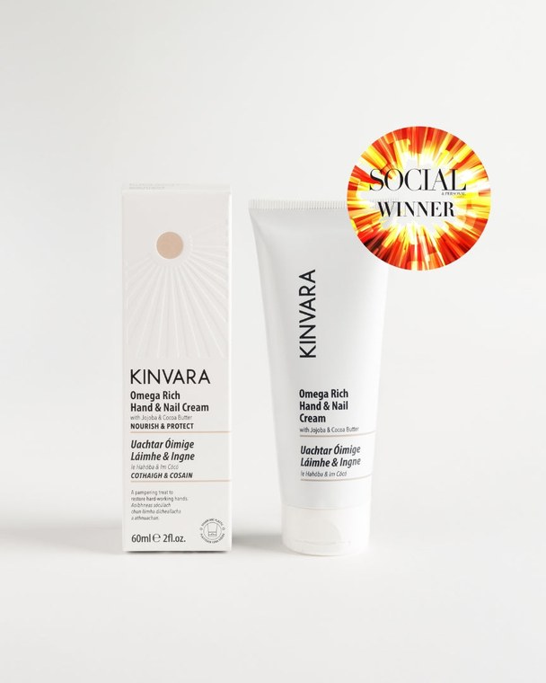 Omega Rich Hand and Nail Cream tube beside its carton, with an award badge
